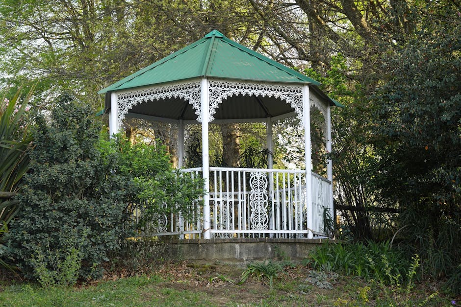 A picturesque white gazebo nestled among lush greenery, perfect for outdoor relaxation.