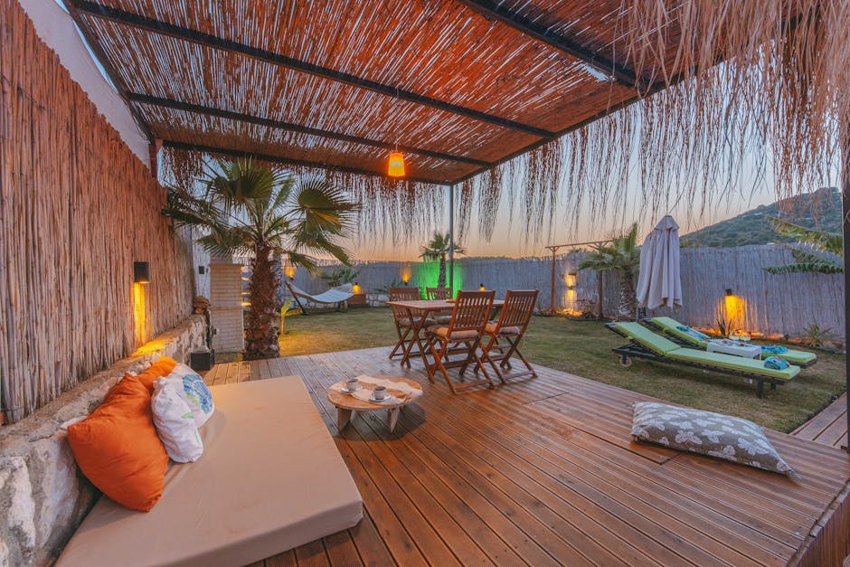 Luxurious outdoor tropical terrace with palm trees and wooden deck during a beautiful sunset. Perfect for relaxation.
